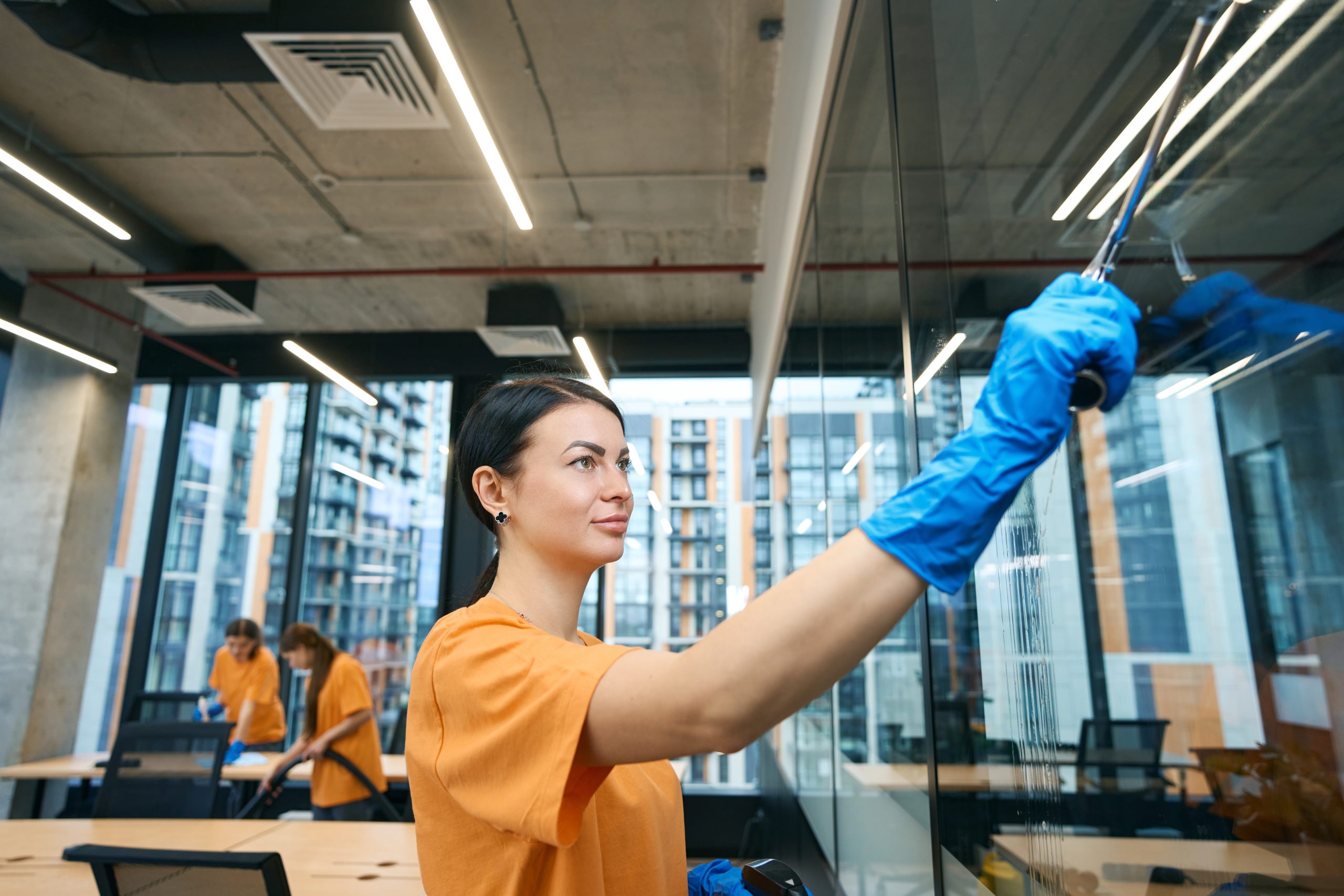 cleaning employees use work gadgets while cleaning and disinfecting surfaces