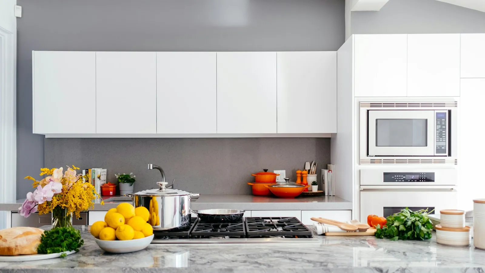 How Often Should You Get Your Tampa Home Cleaned? Bright, clean modern kitchen with white cabinets and tidy stone countertops