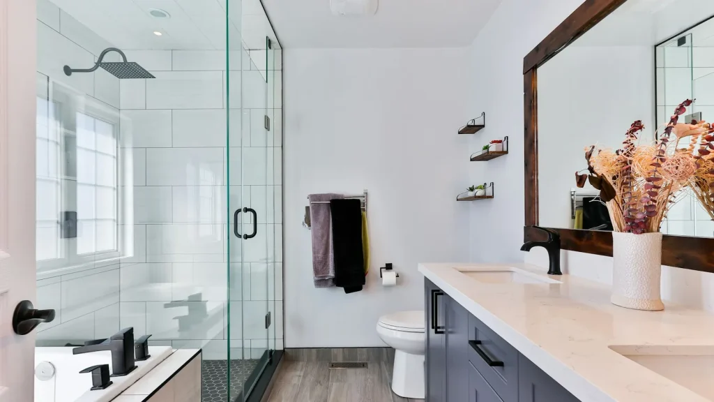 How Much Does House Cleaning Cost in Tampa? Bright, freshly cleaned bathroom with glass shower, double vanity, and clean tile